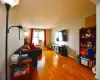 Living area featuring radiator, baseboards, and wood finished floors