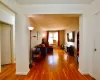 Corridor with radiator, baseboards, and wood finished floors