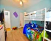 Bedroom with a ceiling fan, baseboards, and wood finished floors