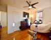 Bedroom with ceiling fan and wood finished floors