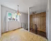 Spare room featuring wood walls, visible vents, and ceiling fan with notable chandelier