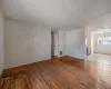 Spare room featuring visible vents, a notable chandelier, and hardwood / wood-style floors