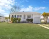 Ranch-style house with an attached garage and a front yard