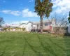 Back of house featuring a residential view, a yard, a deck, and fence