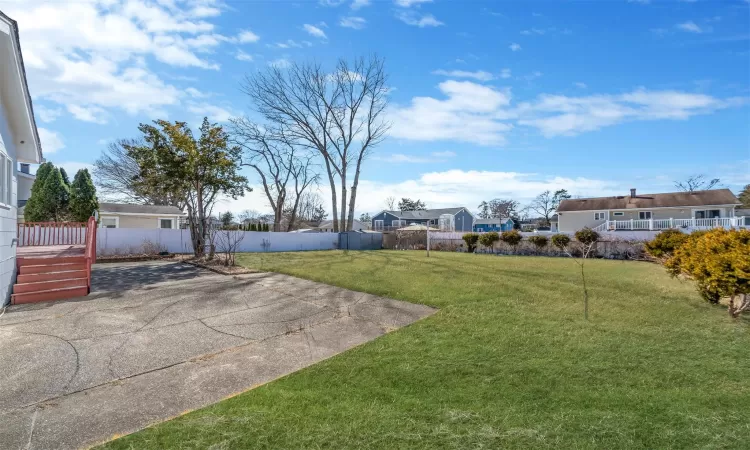 View of yard featuring a fenced backyard and a patio