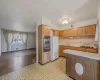 Kitchen with a sink, stainless steel oven, freestanding refrigerator, a warming drawer, and tasteful backsplash