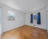 Unfurnished room with hardwood / wood-style floors, cooling unit, and visible vents