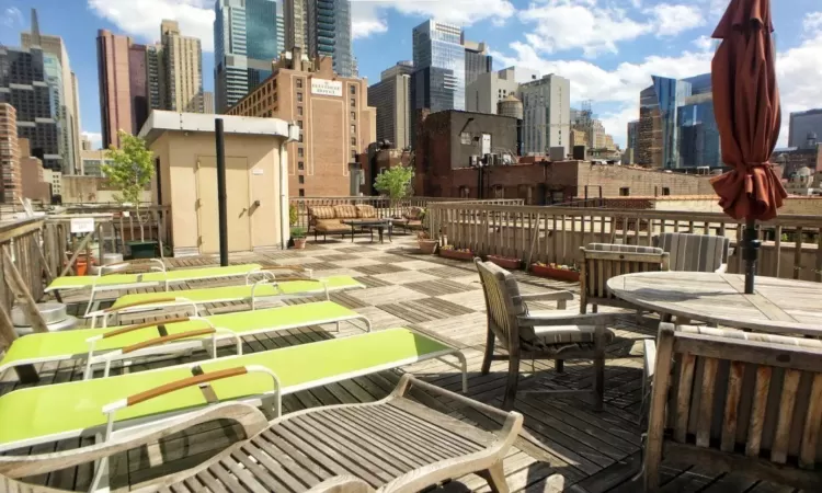 Roof deck featuring a view of city and abundant lounge seating