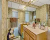 Bathroom featuring wallpapered walls, a baseboard radiator, and vanity