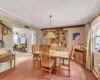 Dining area with light carpet, ornamental molding, and a wealth of natural light