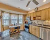 Kitchen featuring stainless steel appliances, dark countertops, tasteful backsplash, a sink, and baseboards