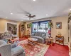 Living room featuring recessed lighting, stairway, ornamental molding, carpet flooring, and ceiling fan