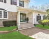 Doorway to property with stone siding and a yard