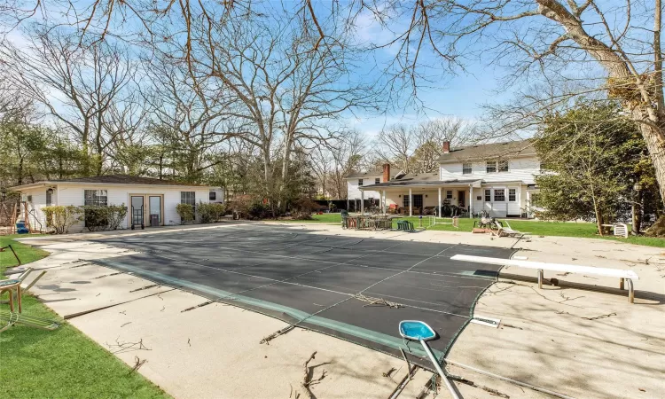 View of pool featuring french doors, a covered pool, a patio, and a diving board