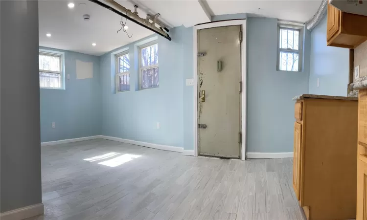 Foyer with recessed lighting, light wood-style flooring, and baseboards