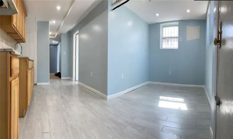 Basement featuring recessed lighting, baseboards, and light wood-style floors