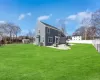 Rear view of property with a patio area, a lawn, and fence