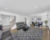 Foyer entrance with wood finished floors, recessed lighting, stairway, crown molding, and baseboards