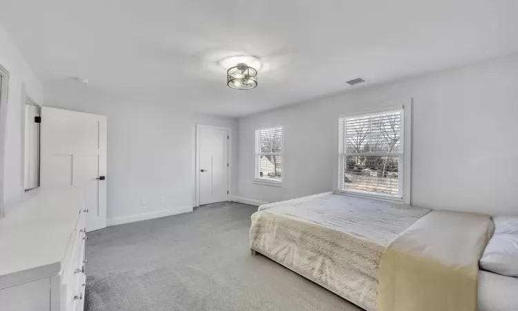 Carpeted bedroom featuring recessed lighting and baseboards