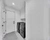 Clothes washing area featuring ornamental molding, cabinet space, baseboards, and washer and clothes dryer