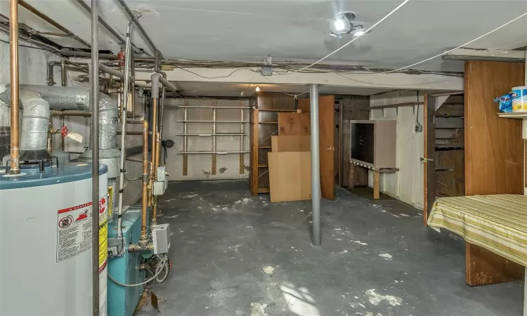 Unfinished below grade area featuring gas water heater