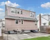 Back of property featuring a shingled roof, a chimney, fence, and a patio