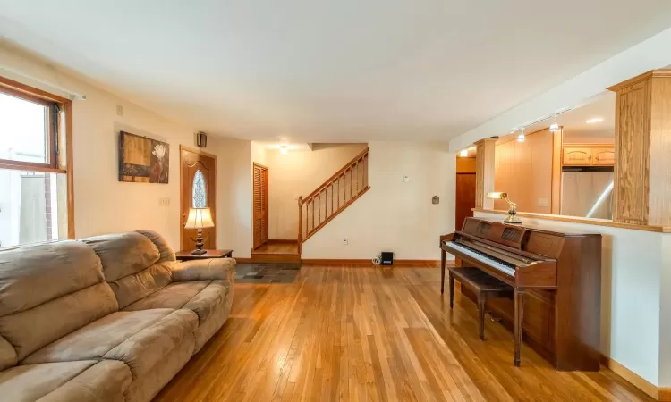 Full bath featuring a stall shower, baseboard heating, and toilet