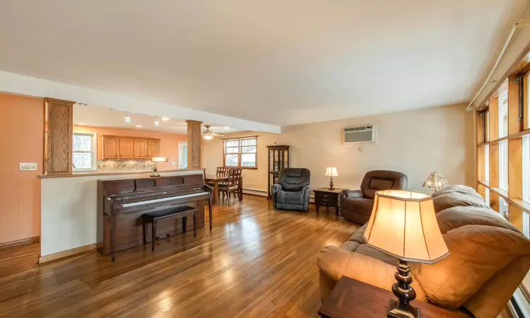 Foyer entrance featuring vaulted ceiling with skylight, light tile patterned floors, brick wall, and plenty of natural light