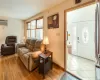 Dining room featuring a baseboard heating unit, wood finished floors, a ceiling fan, baseboards, and ornate columns