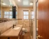 Bedroom with ceiling fan, a closet, ornamental molding, and dark wood-style flooring