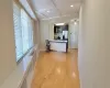 Kitchen featuring baseboards, coffered ceiling, appliances with stainless steel finishes, light wood-style floors, and beam ceiling