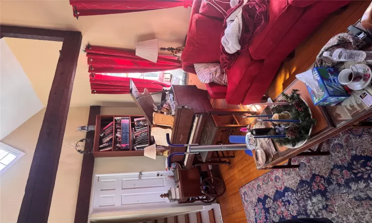 Living area featuring stairway, lofted ceiling, and hardwood / wood-style flooring