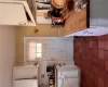 Kitchen with wood counters, tasteful backsplash, white cabinets, and dark tile patterned flooring