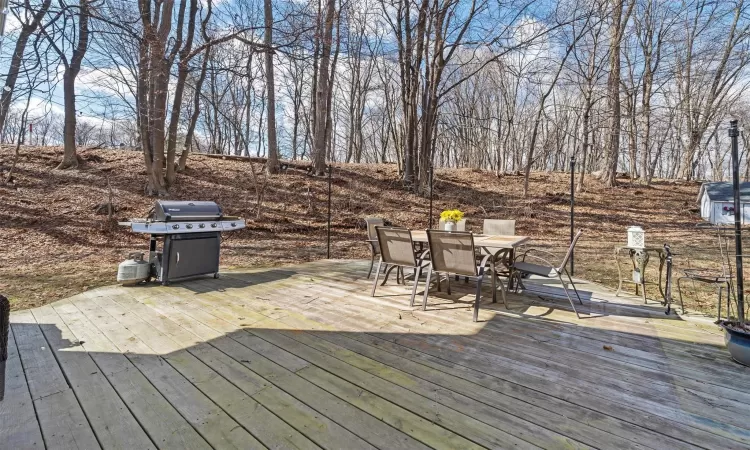 Deck with a grill and outdoor dining space