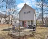 Back of property with a deck and fence