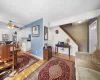 Living room featuring baseboards, light wood-type flooring, and ceiling fan