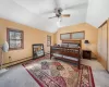 Bedroom with a baseboard heating unit, lofted ceiling, and carpet floors