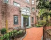 Doorway to property featuring brick siding