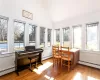 Sunroom featuring vaulted ceiling and a baseboard radiator