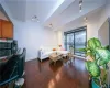 Living room featuring beamed ceiling, rail lighting, wood finished floors, and baseboards