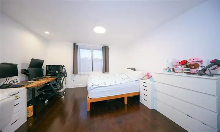 Bedroom featuring recessed lighting, wood finished floors, and baseboards