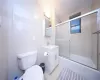 Full bathroom featuring enclosed tub / shower combo, toilet, and vanity