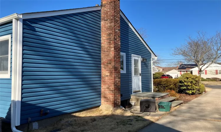 View of side of property with a chimney