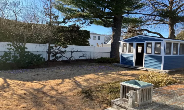 View of yard featuring an outbuilding and a fenced backyard