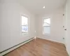 Spare room featuring light wood finished floors, baseboard heating, recessed lighting, and baseboards