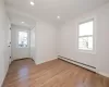 Spare room featuring recessed lighting, light wood finished floors, and a baseboard radiator