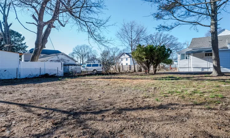 View of yard featuring fence