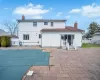 Back of house with a patio area, fence, and a chimney