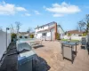 View of patio featuring grilling area, a residential view, outdoor dining area, and a fenced backyard