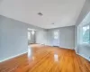 Empty room with visible vents, baseboards, light wood-style floors, and an inviting chandelier